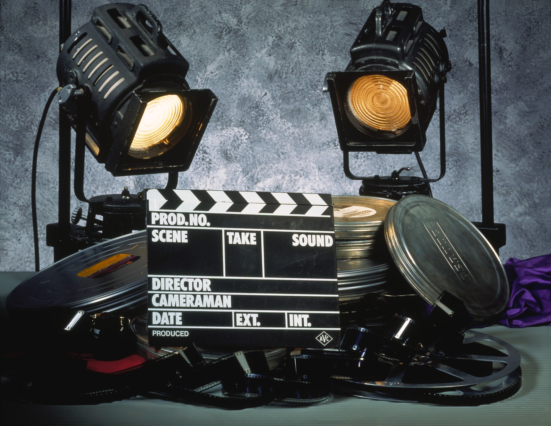 Clapperboard, film and two floodlights